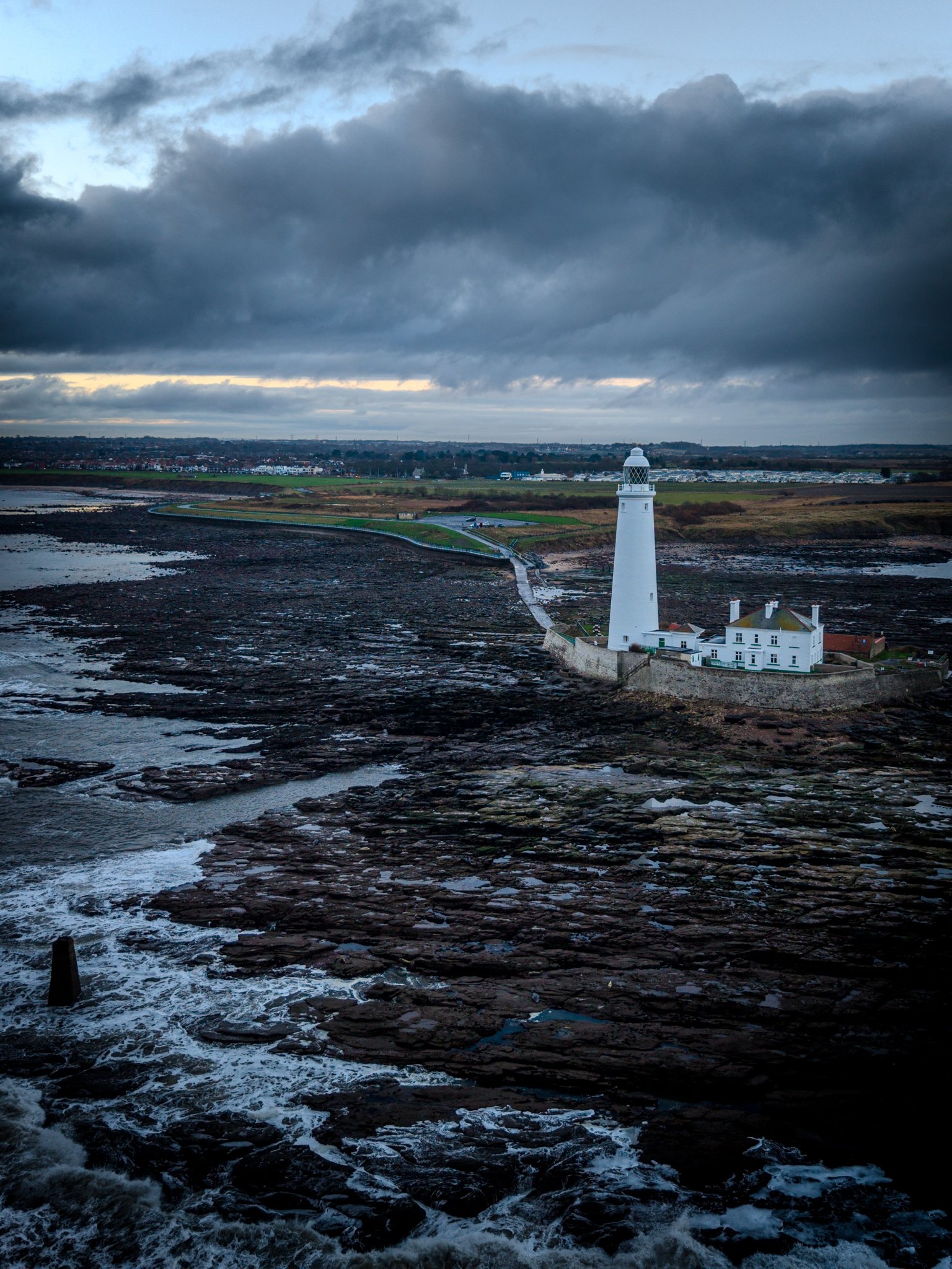 St. Mary's Lighthouse, Whitley Bay, surrounded by rocks as the tide recedes